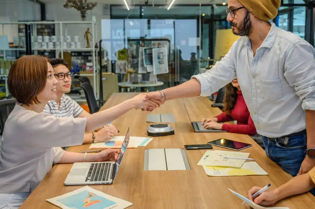 Business owners making a handshake agreement before signing a contract